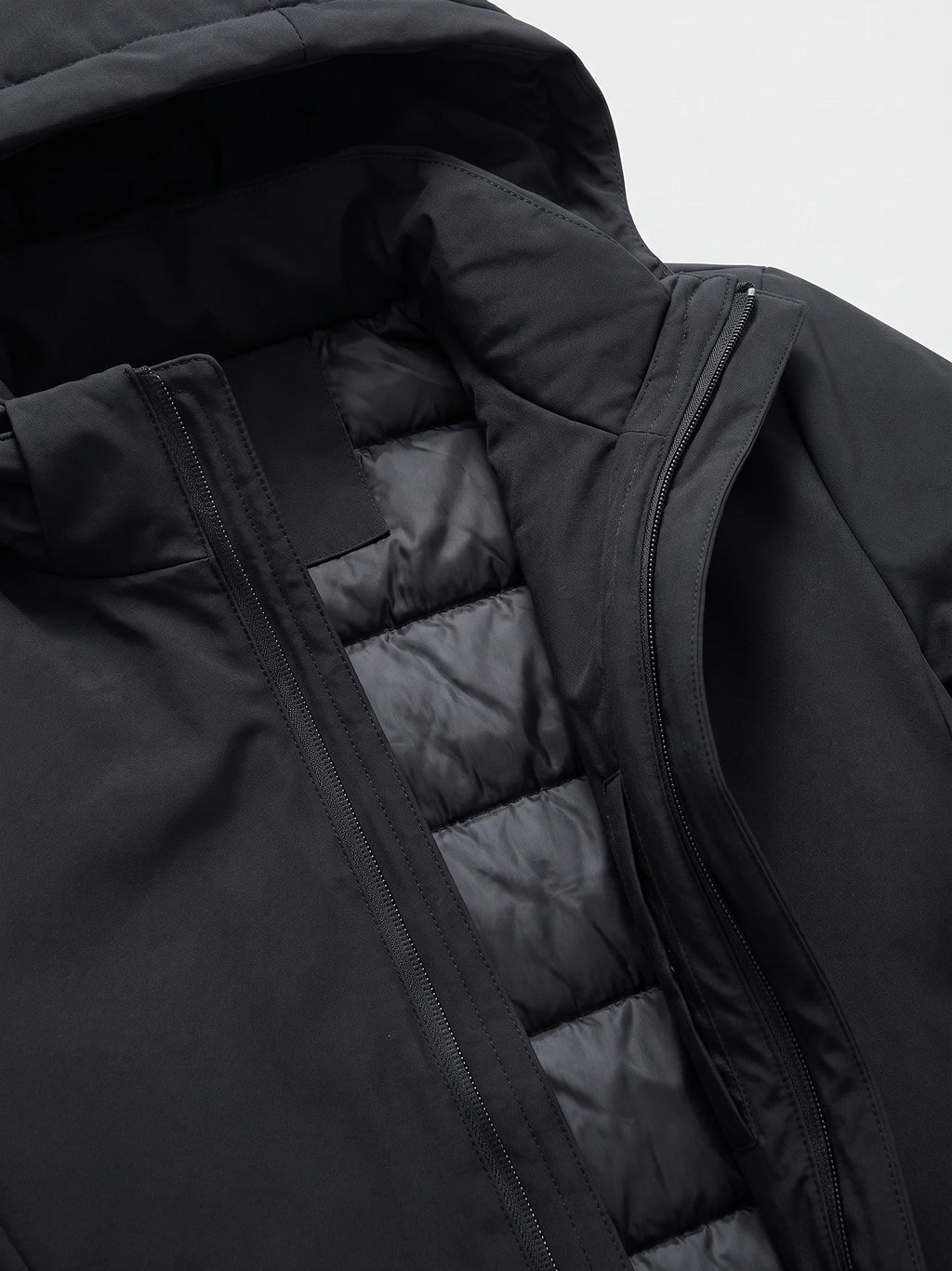 Close-up of the Black hooded trench coat showing the front zipper, storm flap, and quilted padded lining.