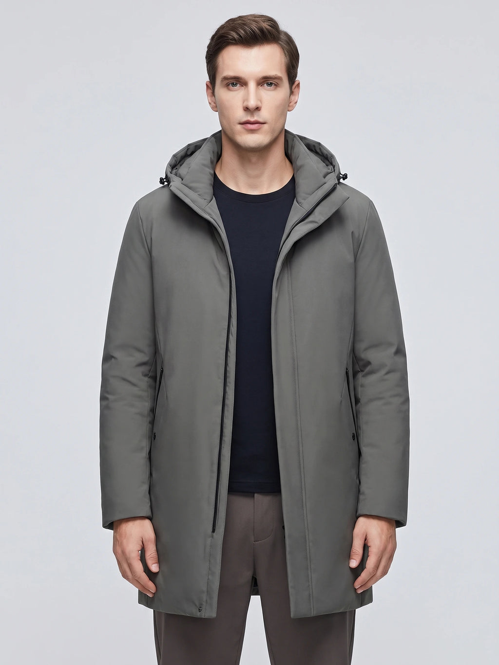 Front studio view of a model wearing a Gray hooded trench coat with a zip front and side pockets.