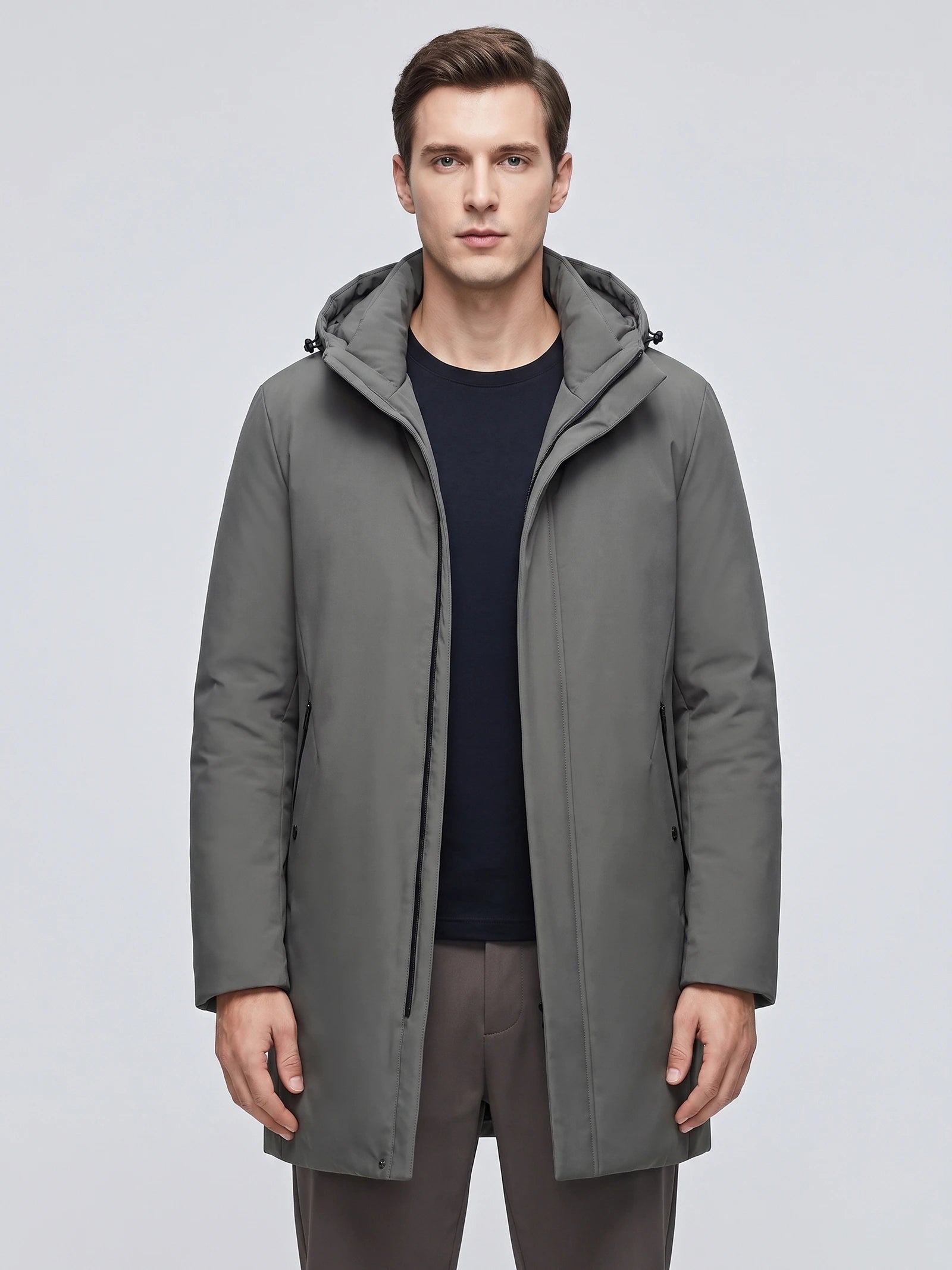 Front studio view of a model wearing a Gray hooded trench coat with a zip front and side pockets.