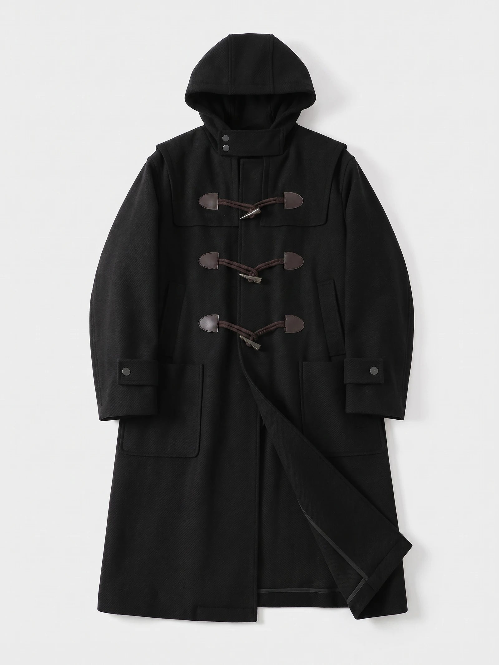 Black wool hooded trench coat laid flat, featuring toggle closures, flap pockets, cuff tabs, and a belted waist.