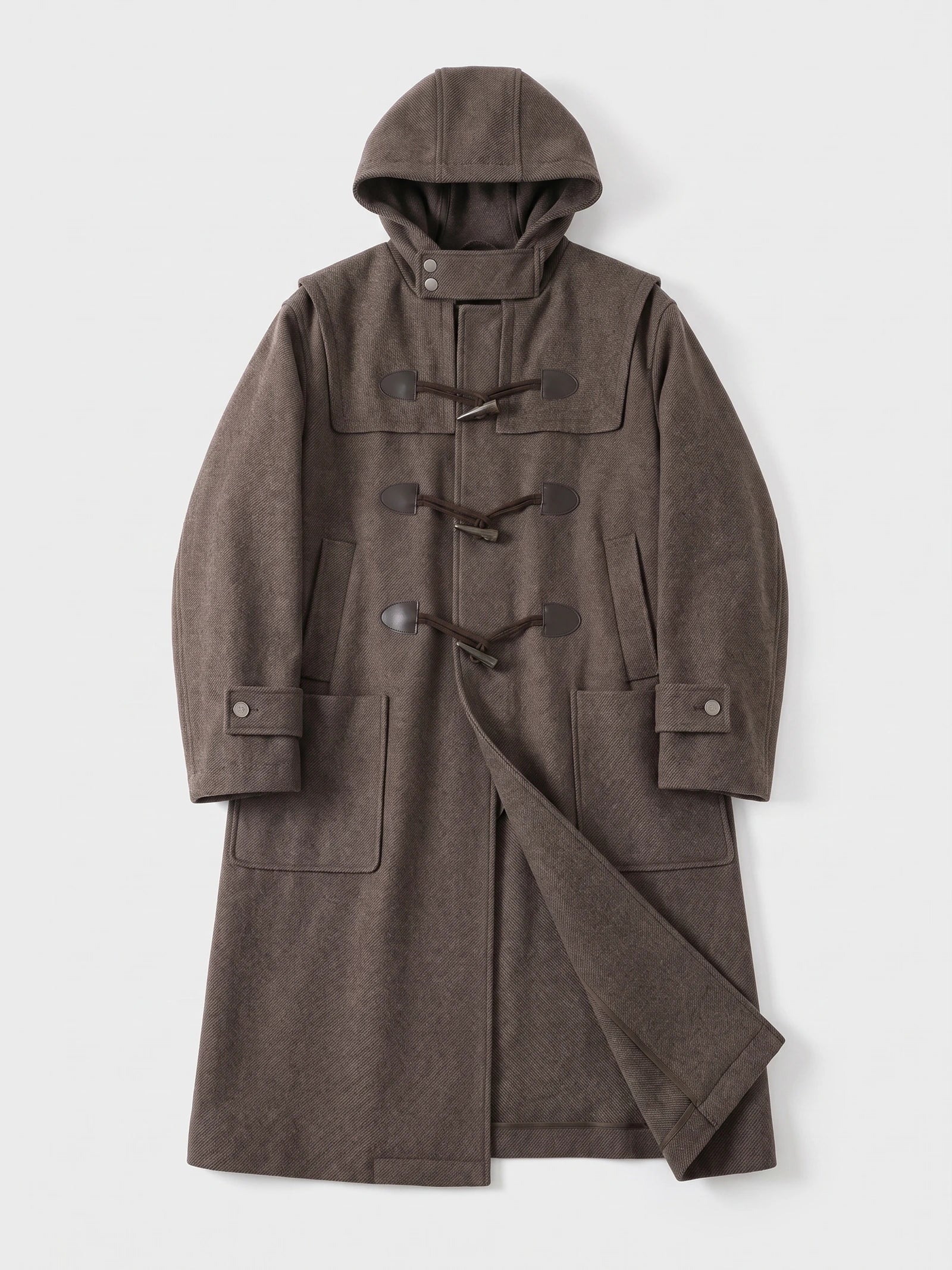 Brown men's wool trench coat laid flat, featuring a hood, toggle fastenings, cuff tabs, patch pockets, and a loose belt.