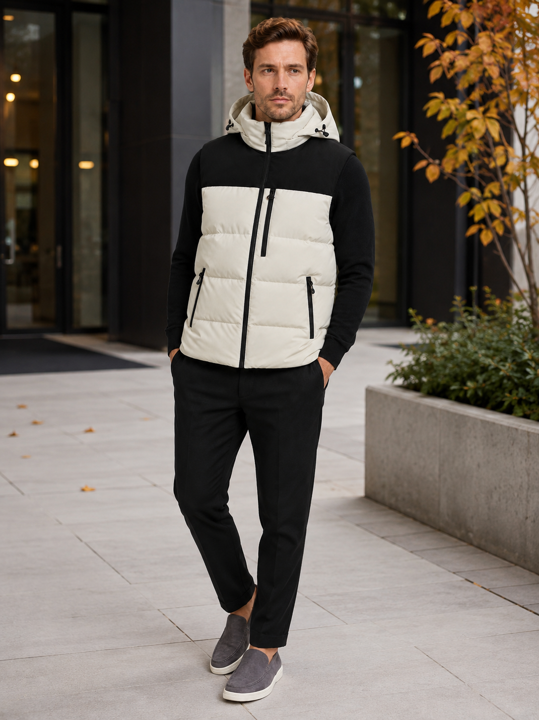 Man wearing a beige hooded puffer vest in a casual fall winter outfit for outdoor and everyday wear