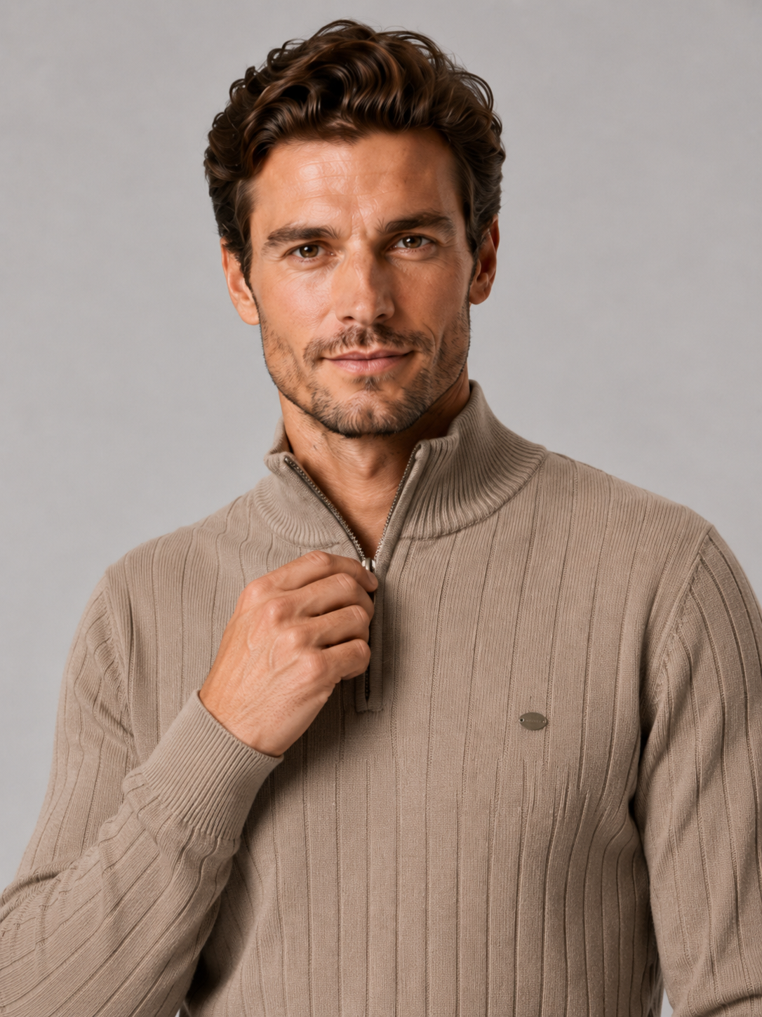 Close-up of a dark gray quarter zip pullover sweater showing the cotton knit texture, stand collar, zipper placket, cuffs, hem, and stitching details