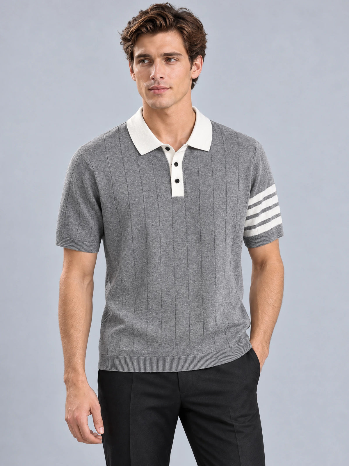 Front studio view of a model wearing a Gray Knit Polo with a textured knit body, contrast collar, and striped short sleeves.