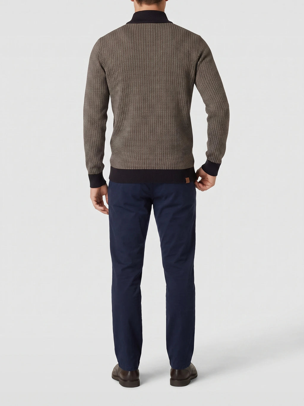 Rear studio view of a model wearing a Brown cotton Knit Quarter Zip Sweater with textured knit and ribbed mock neck, cuffs, and hem.