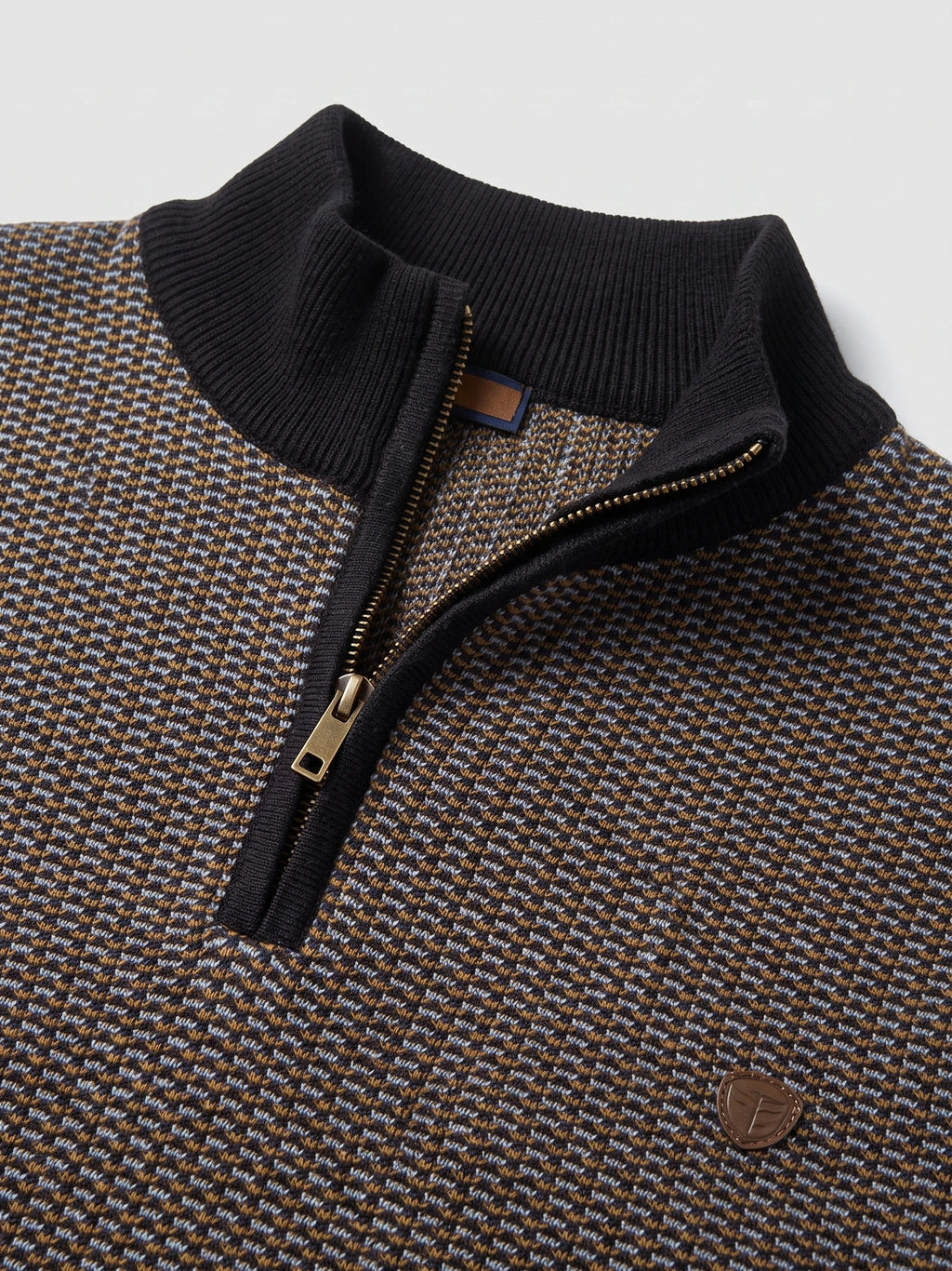 Brown cotton Knit Quarter Zip Sweater detail showing the ribbed mock neck, metal zipper, and textured knit pattern.