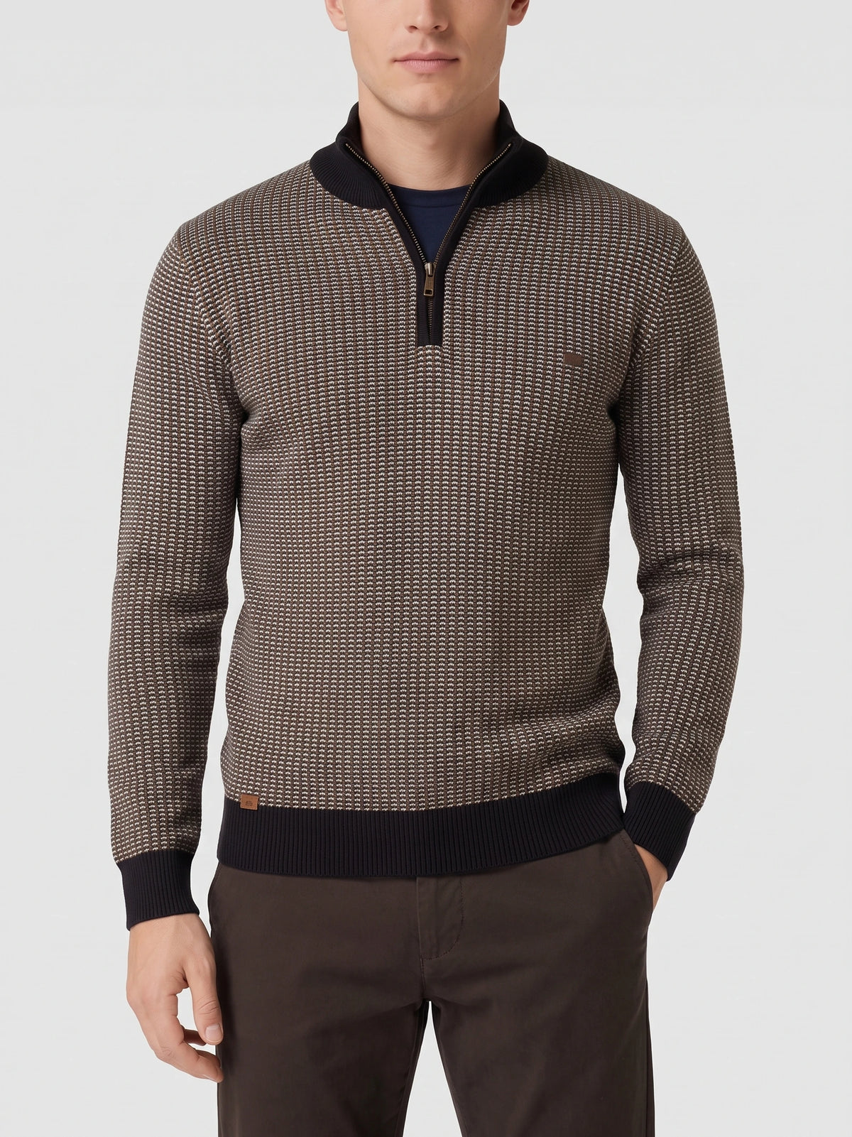 Model wearing a Brown knit quarter zip sweater with a textured knit pattern and ribbed mock neck in a front studio view.