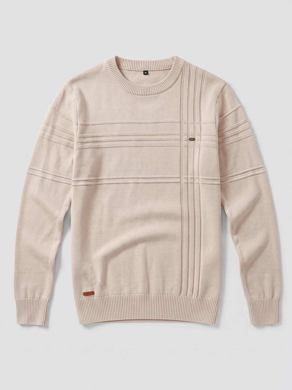 Beige knitted cotton crewneck sweater laid flat, featuring ribbed trims and raised linear knit details across the front and sleeves.
