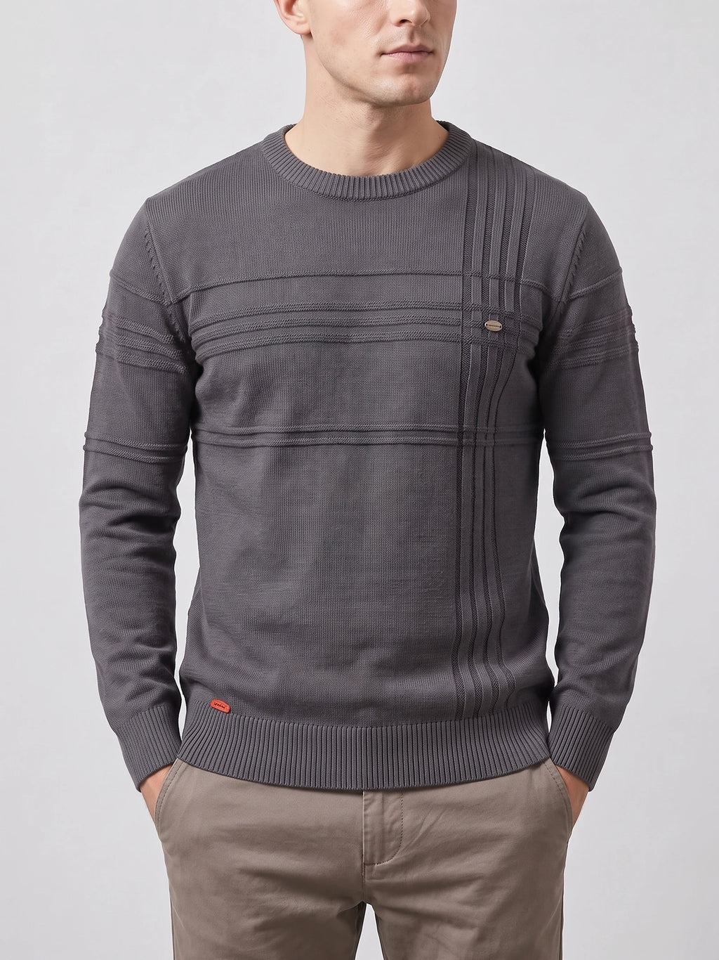Front studio view of a model wearing a Charcoal knitted cotton crewneck sweater with ribbed trim and textured panel detailing.