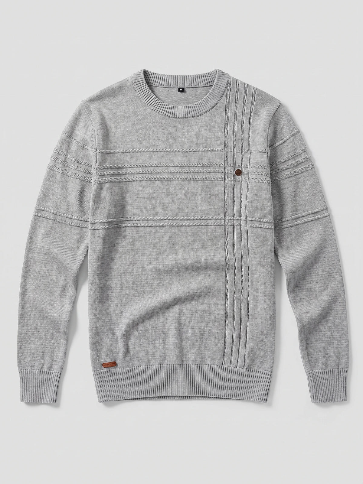 Gray knitted cotton crewneck sweater laid flat, featuring ribbed trim, textured horizontal bands, and a vertical knit panel with a button.