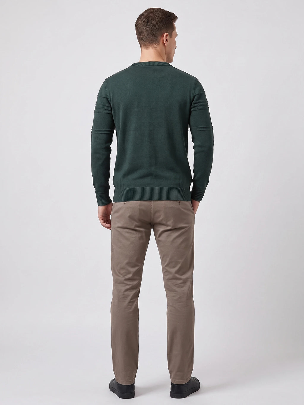 Rear studio view of a model wearing a Green knitted cotton crewneck sweater with ribbed trim and textured sleeve bands.