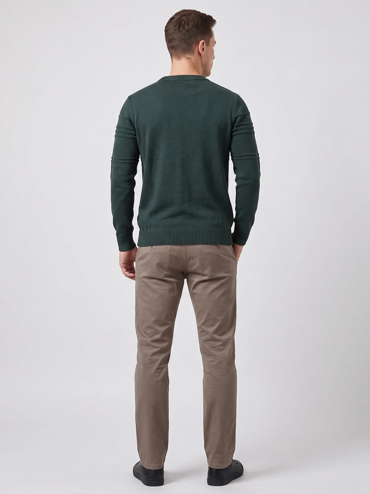 Rear studio view of a model wearing a Green knitted cotton crewneck sweater with ribbed trim and textured sleeve bands.