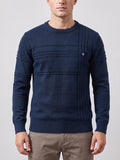 Front studio view of a model wearing a Navy Knitted Cotton Sweater with a ribbed crewneck, textured paneling, and a chest button detail.