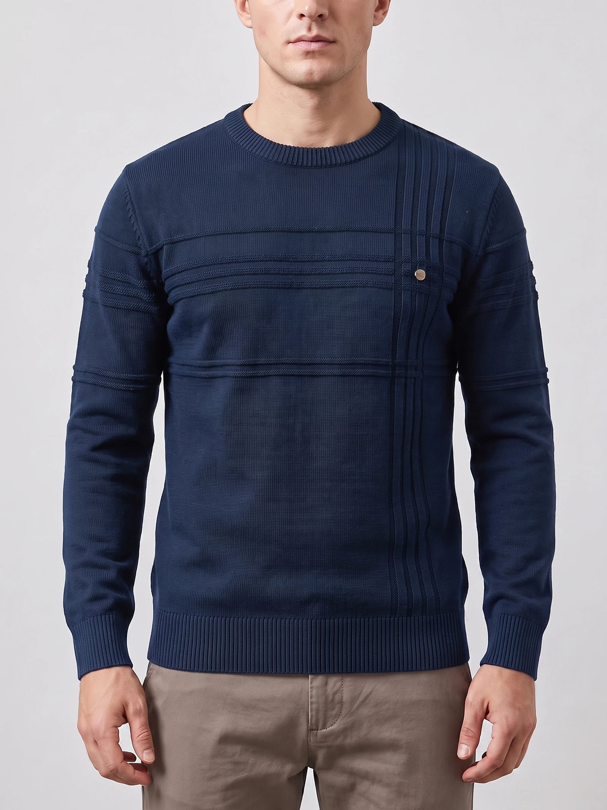 Front studio view of a model wearing a Navy Knitted Cotton Sweater with a ribbed crewneck, textured paneling, and a chest button detail.