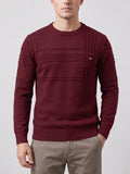 Front studio view of a model wearing a Wine knitted cotton crewneck sweater with ribbed trim and textured vertical chest detailing.