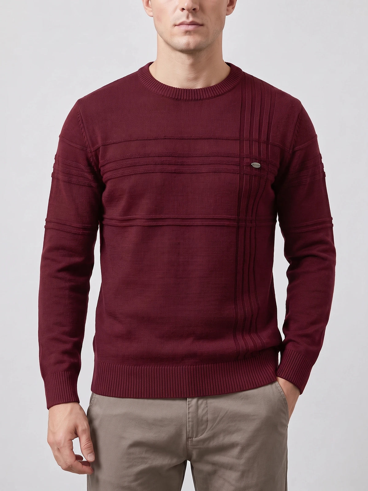 Front studio view of a model wearing a Wine knitted cotton crewneck sweater with ribbed trim and textured vertical chest detailing.