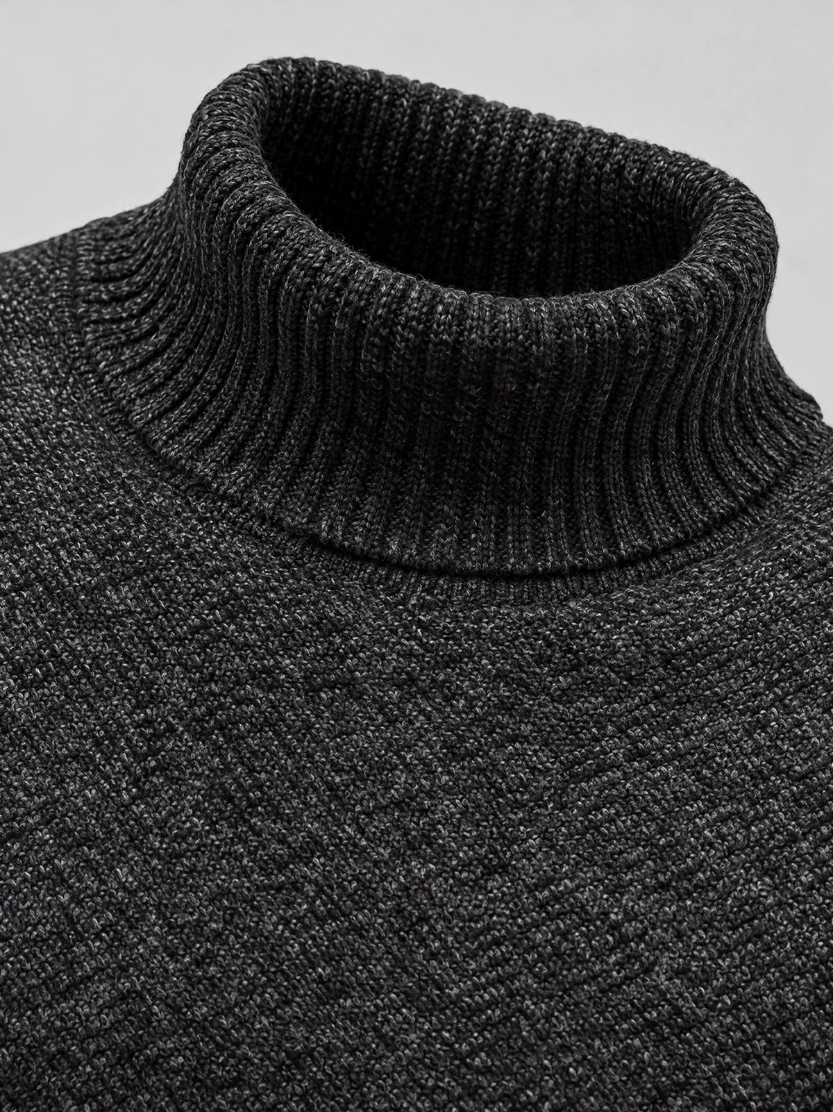 Close-up of the ribbed collar and textured knit of a Black men's Knitted Turtleneck Sweater.