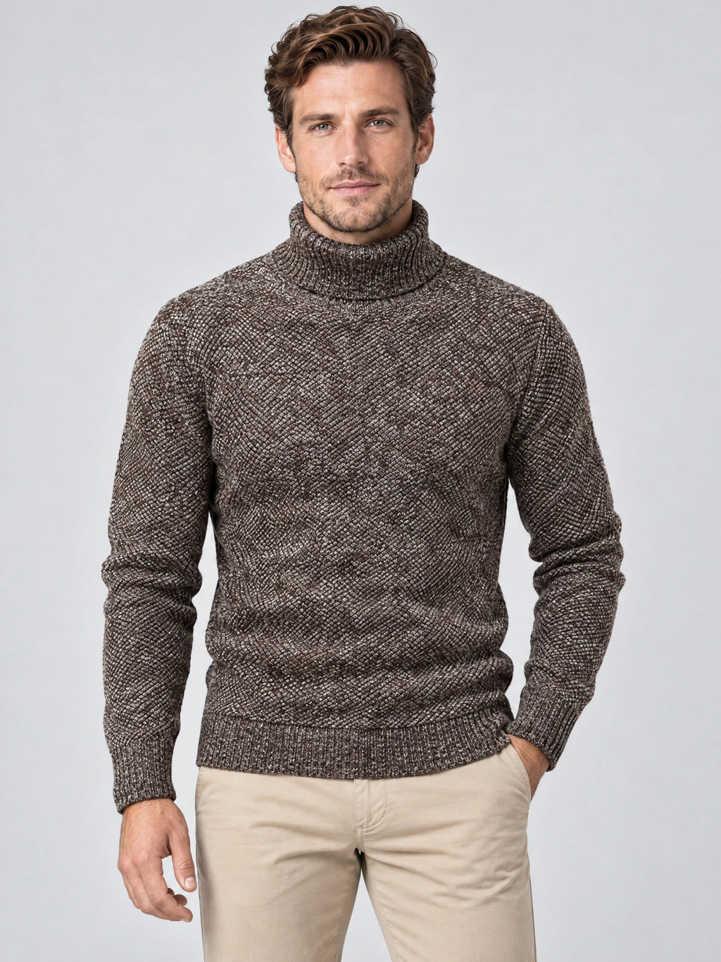 Front studio view of a model wearing a Brown knitted turtleneck sweater with textured wool knit and ribbed trim.