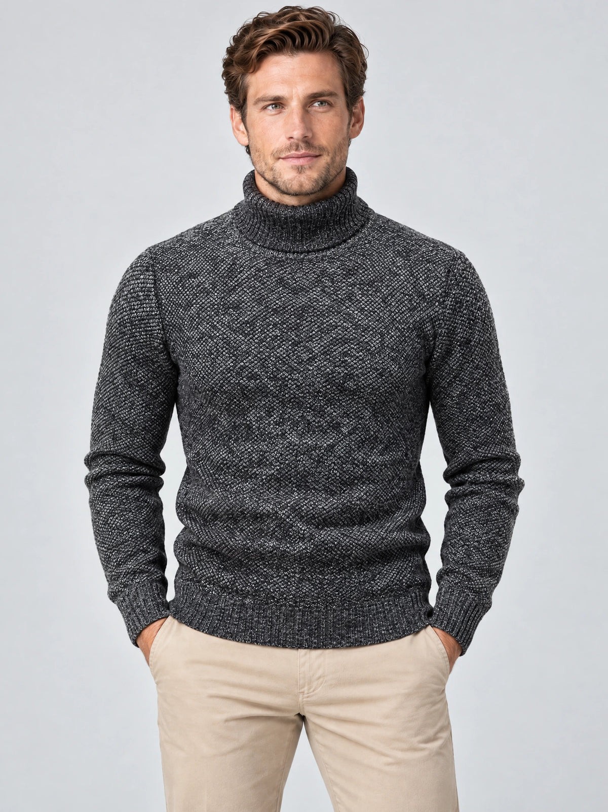 Front studio view of a model wearing a Gray knitted turtleneck sweater with ribbed collar, cuffs, and hem.