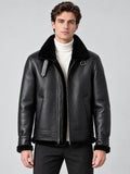 Front studio view of a model wearing a Black Leather Aviator Jacket with a plush collar, zip front, buckle tabs, and angled pockets.