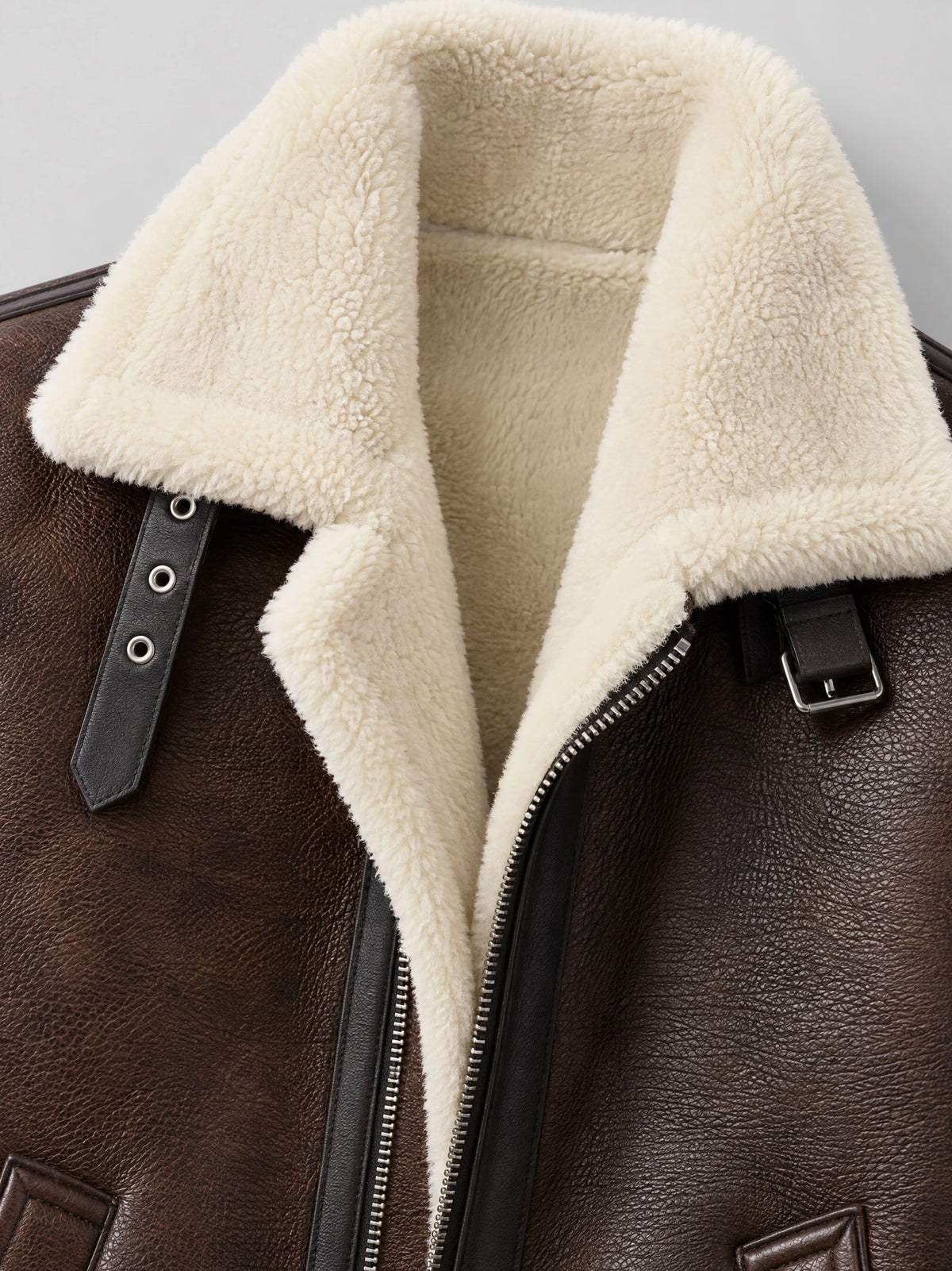 Brown Leather Aviator Jacket close-up showing the plush shearling-style collar, front zipper, and buckle strap detail.