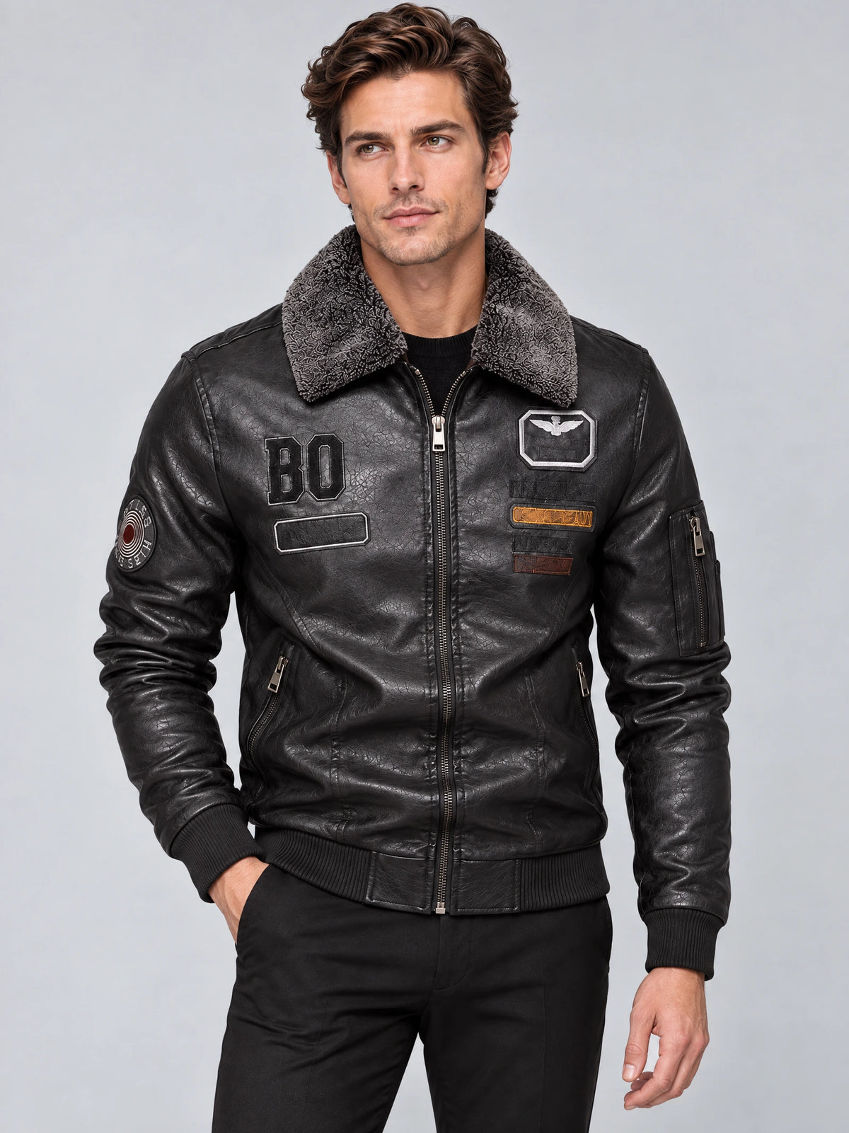 Front studio view of a model wearing a Gray Leather Aviator Jacket with a fur collar, zip front, chest patches, and sleeve pocket.