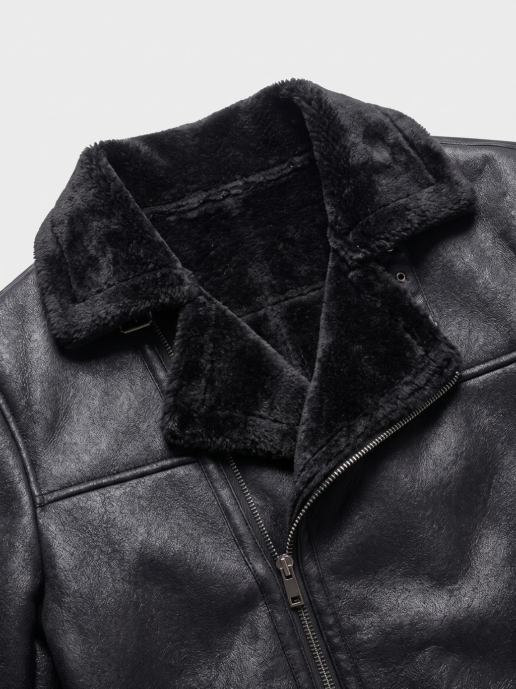 Close-up of a Black men’s PU leather bomber jacket with a plush aviator collar, zip front, and textured leather-look finish.