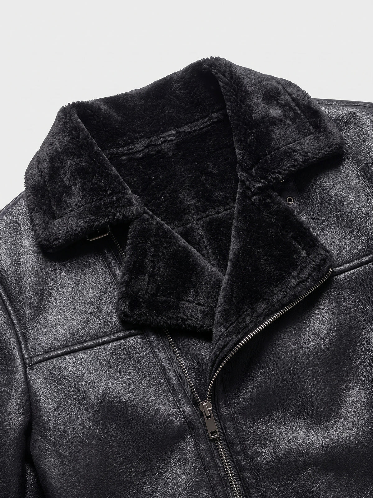 Close-up of a Black men’s PU leather bomber jacket with a plush aviator collar, zip front, and textured leather-look finish.