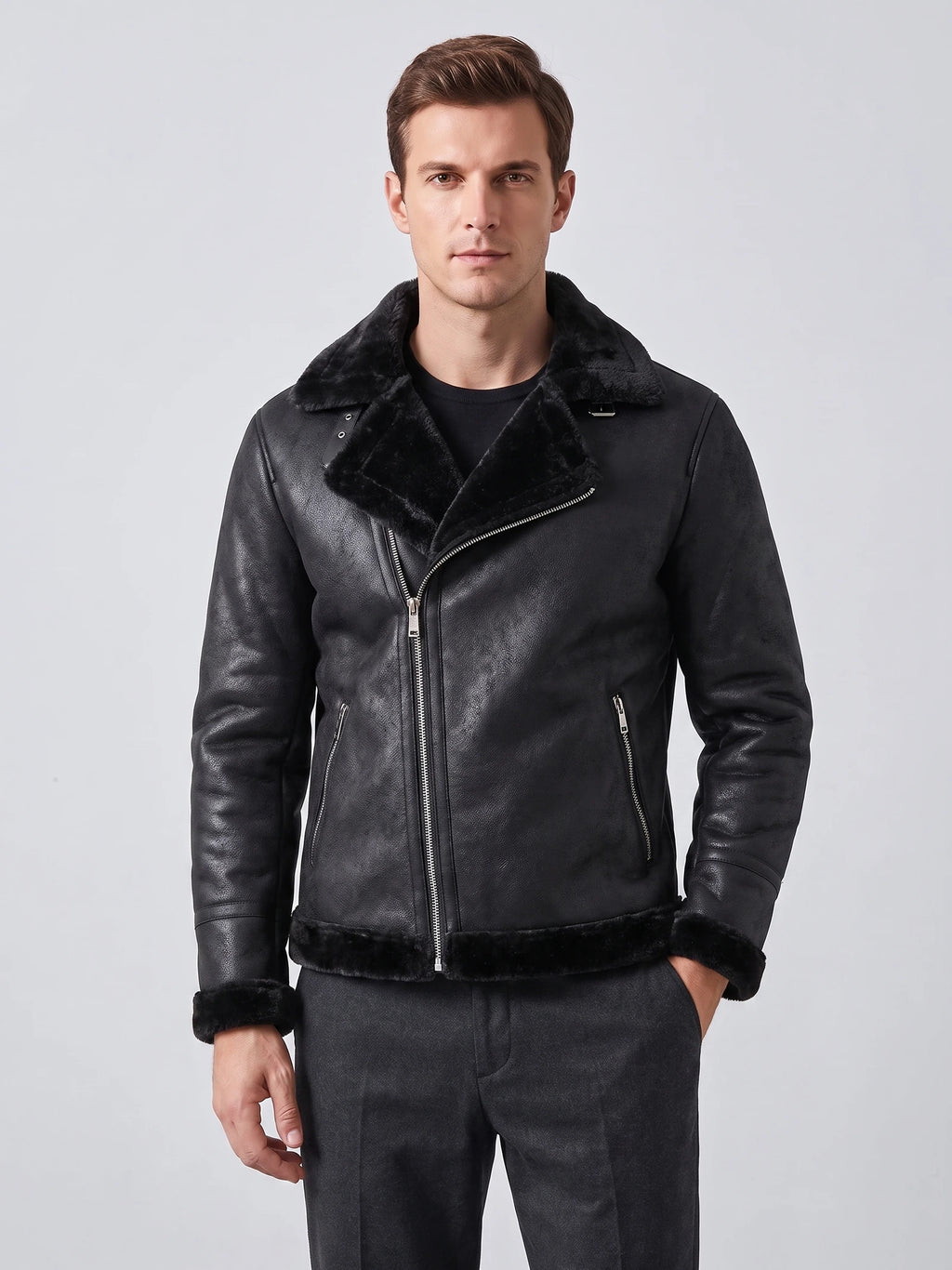 Front studio view of a model wearing a Black aviator-style PU leather jacket with a plush collar, angled zipper, and zip pockets.
