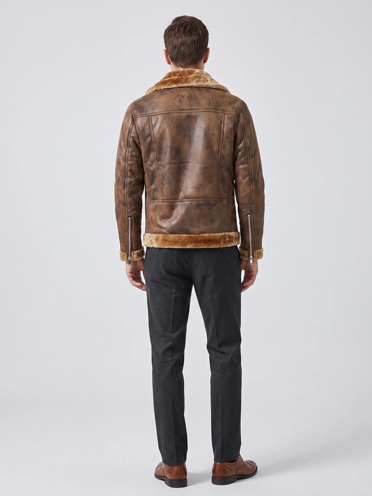 Rear studio view of a model wearing a Brown aviator-style PU leather jacket with a shearling-style collar, hem trim, and zip cuffs.