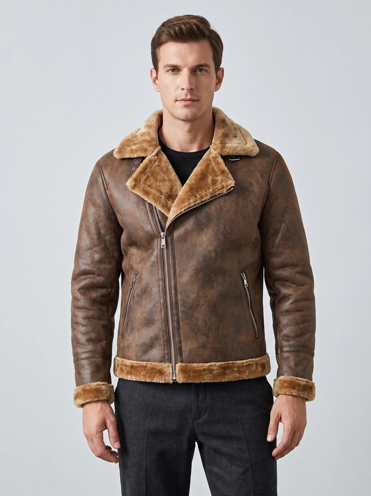 Front studio view of a model wearing a Brown aviator-style PU leather jacket with a plush collar, asymmetric zip, and zippered pockets.