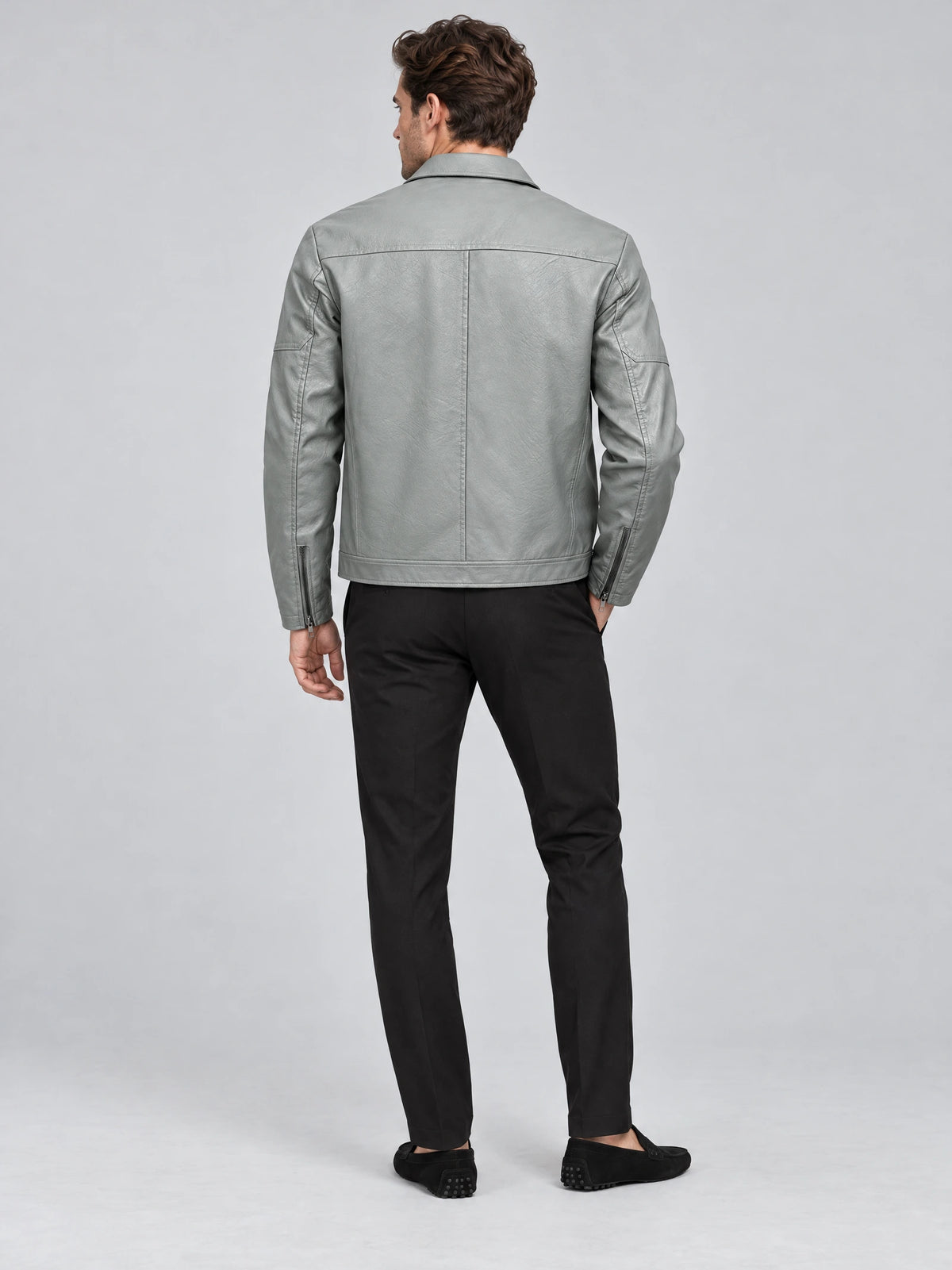 Rear studio view of a model wearing a Gray leather bomber jacket with a paneled back and zip cuffs.