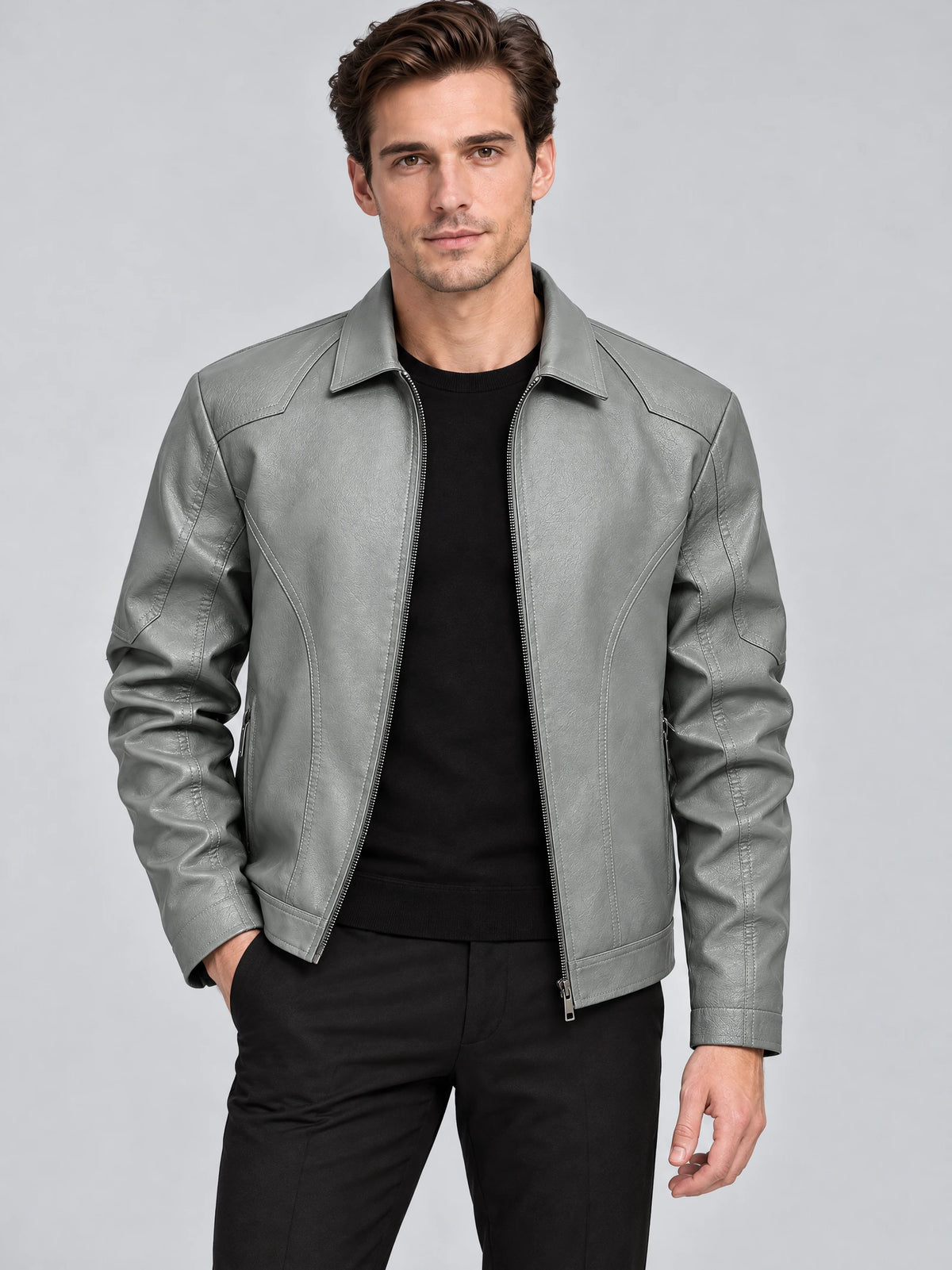 Front studio view of a model wearing a Gray leather bomber jacket with a pointed collar, zip front, and stitched sleeve panels.