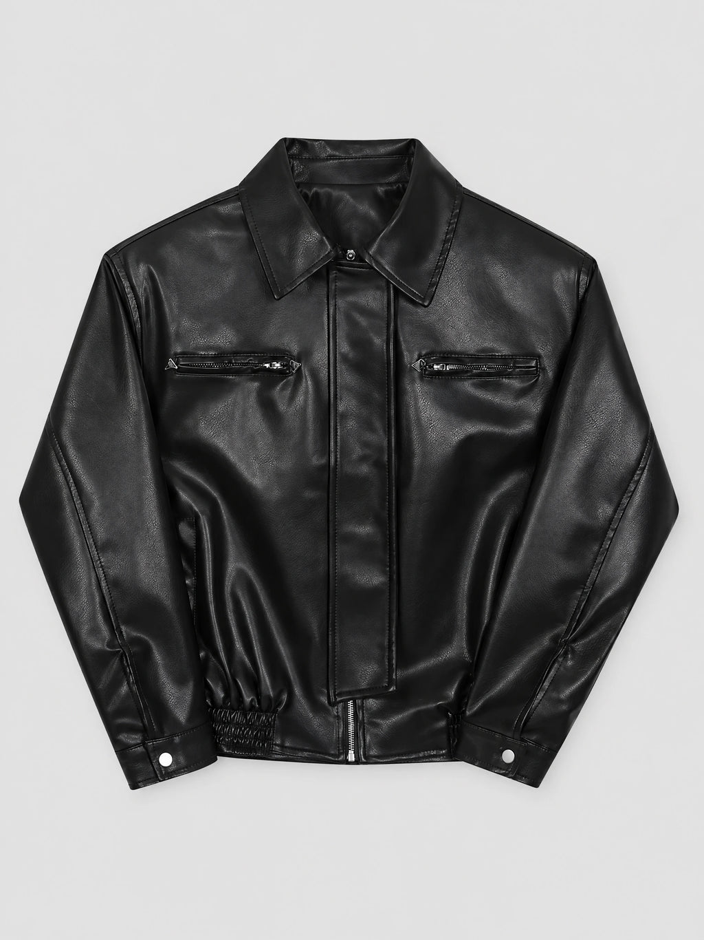 Black leather bomber jacket laid flat, showing a lapel collar, central zipper, zippered chest pockets, and snap cuffs.