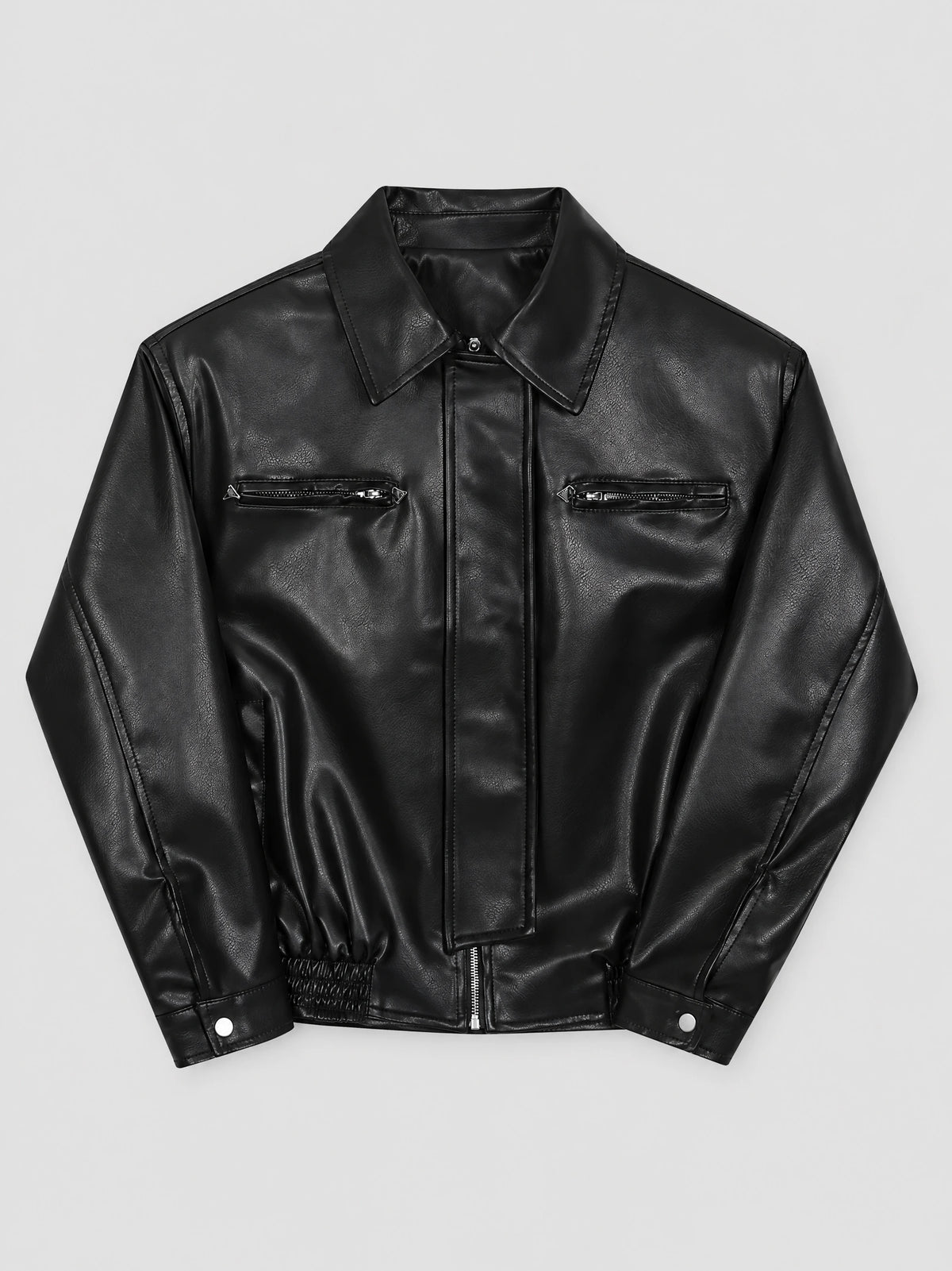Black leather bomber jacket laid flat, showing a lapel collar, central zipper, zippered chest pockets, and snap cuffs.