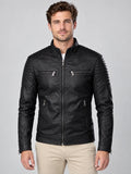 Front studio view of a model wearing a Black Leather Fall Jacket with a stand collar, quilted shoulders, and zippered chest and side pockets.