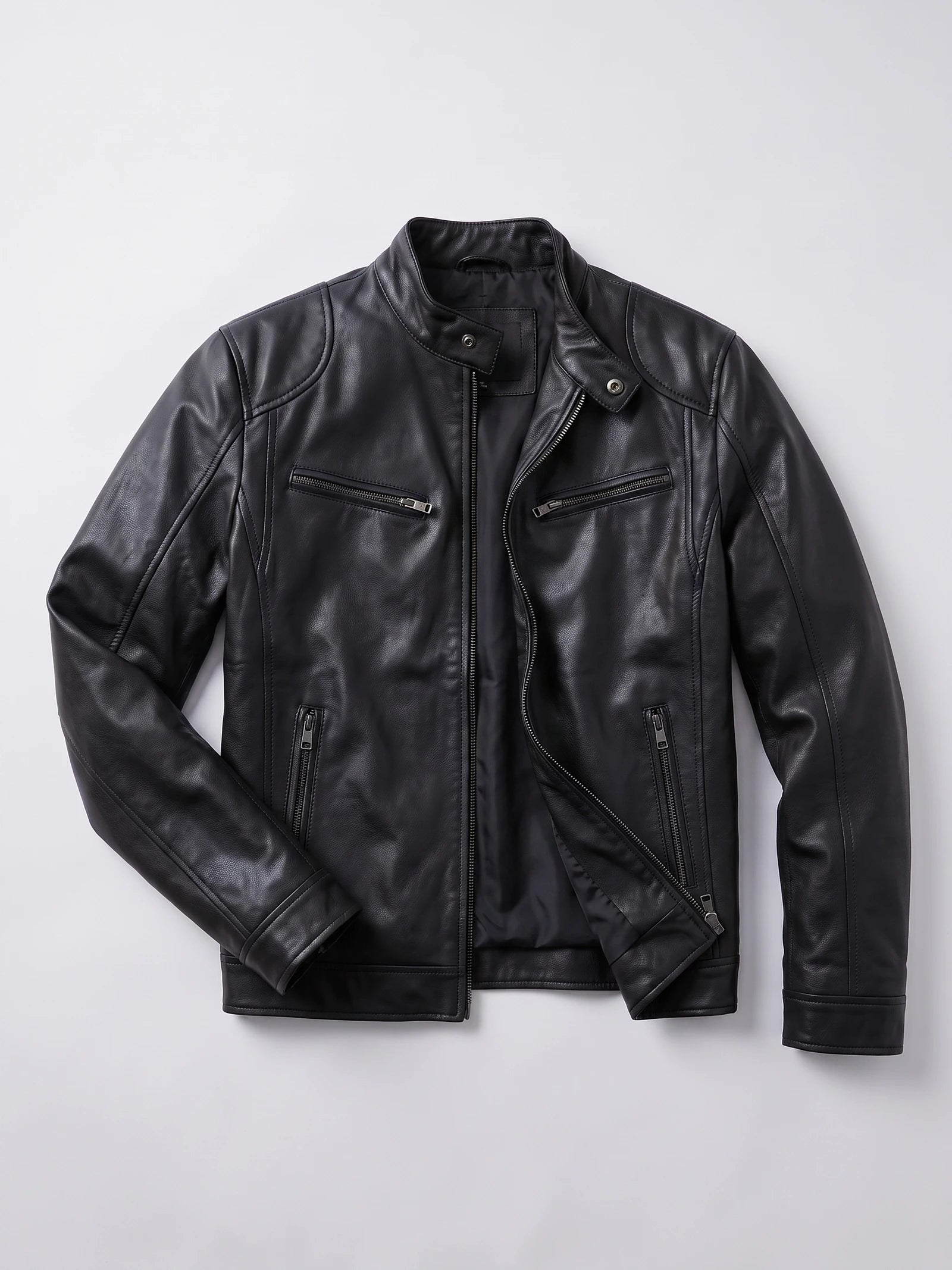 Black Men's Leather Jacket laid flat, showing an asymmetrical front zipper, snap-tab collar, and zippered chest and side pockets.