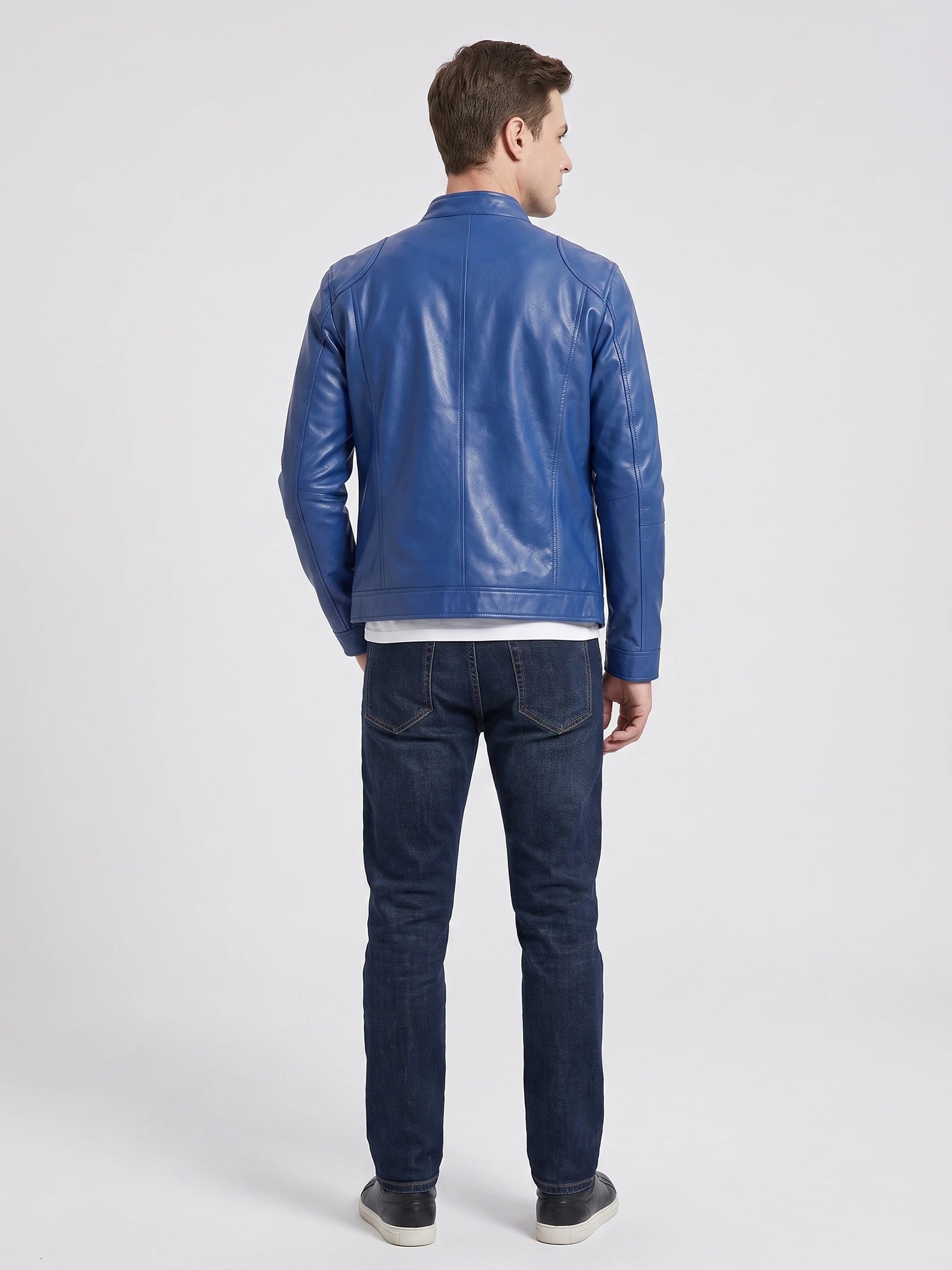 Rear studio view of a model wearing a Blue Men's Leather Jacket with paneled back stitching and a stand collar.