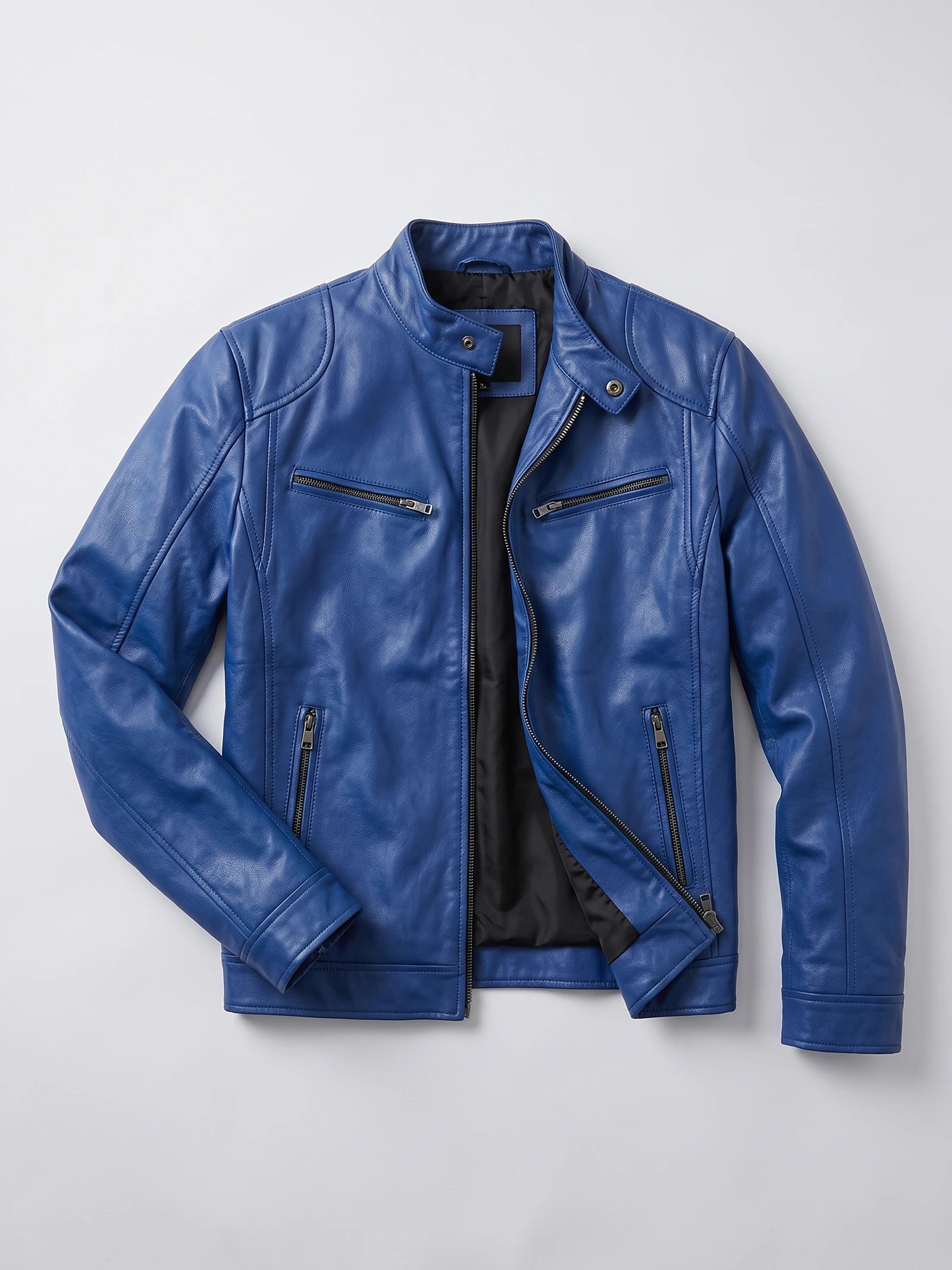 Blue men's leather jacket laid flat with an asymmetrical front zip, snap-tab collar, and multiple zip pockets.