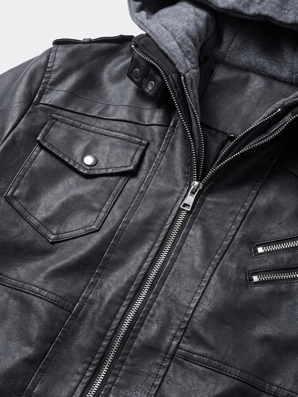 Close-up of a Black mens leather jacket with textured PU leather, snap-flap chest pocket, and silver zipper detailing.