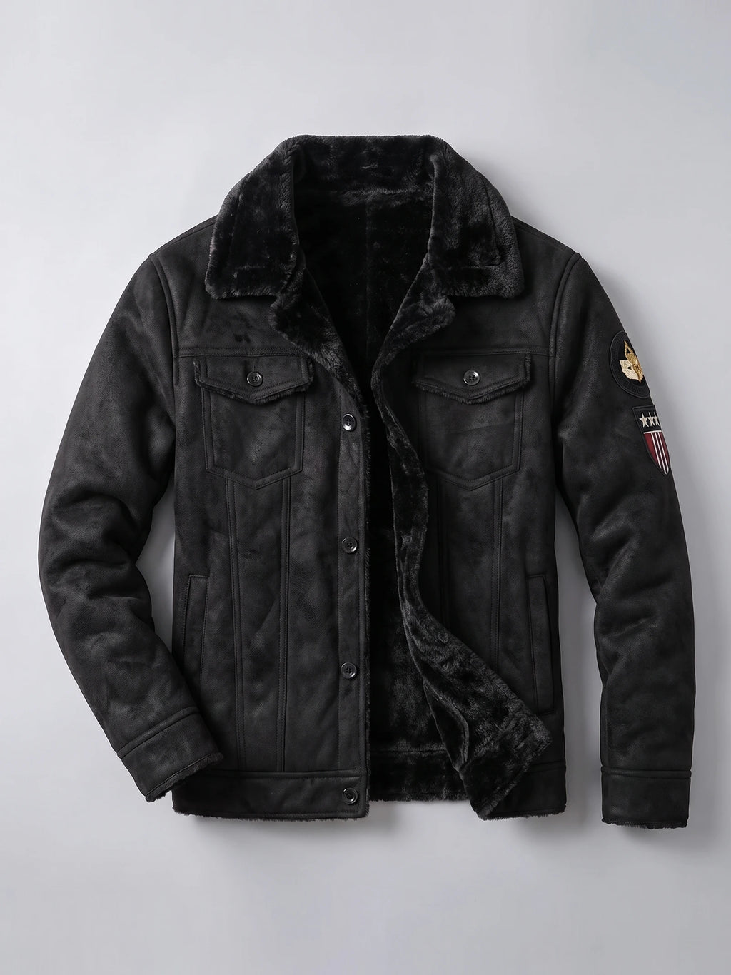 Black leather jacket laid flat with a plush fleece lining, button-front closure, chest pockets, and sleeve patches.