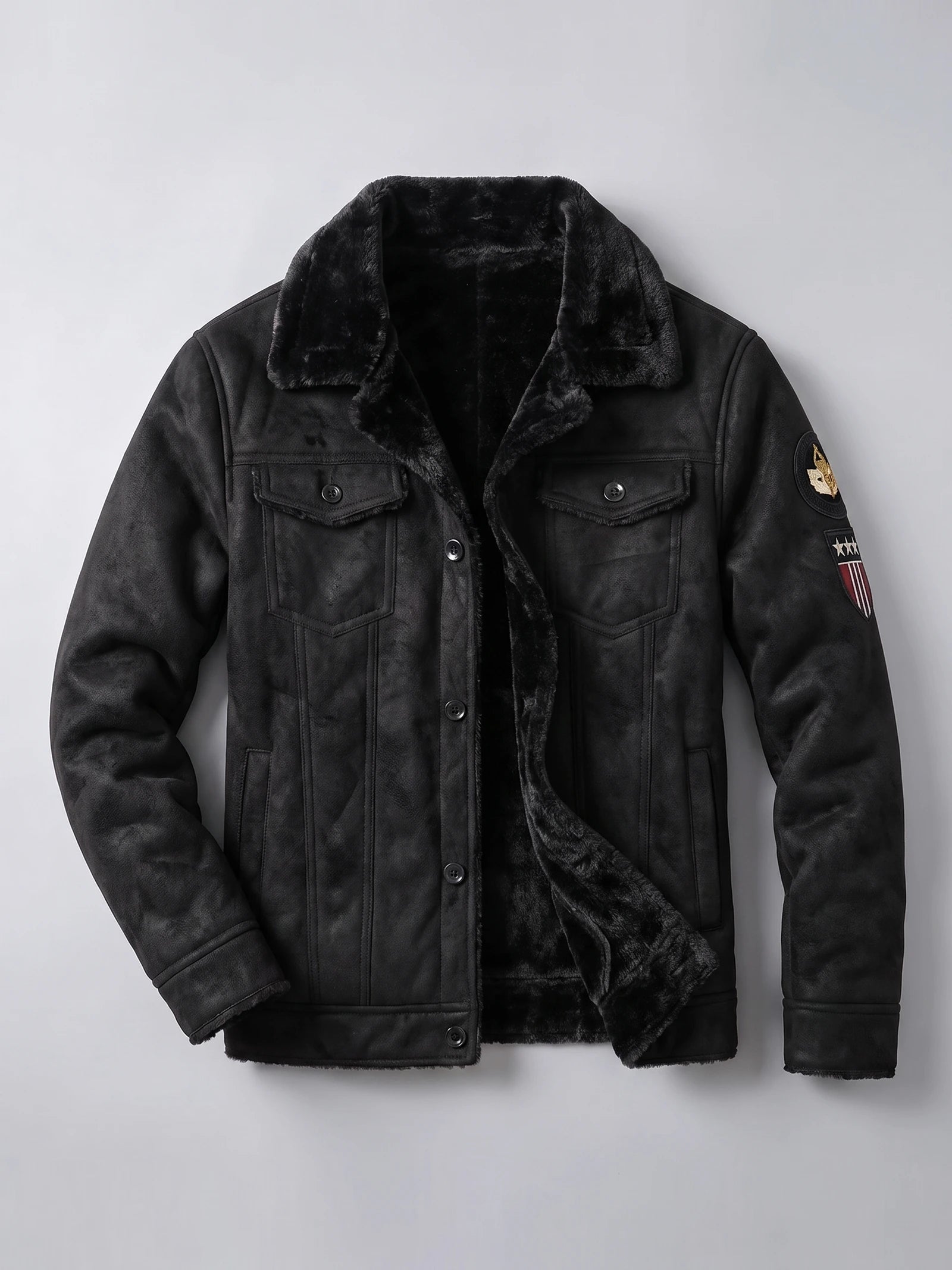 Black leather jacket laid flat with a plush fleece lining, button-front closure, chest pockets, and sleeve patches.