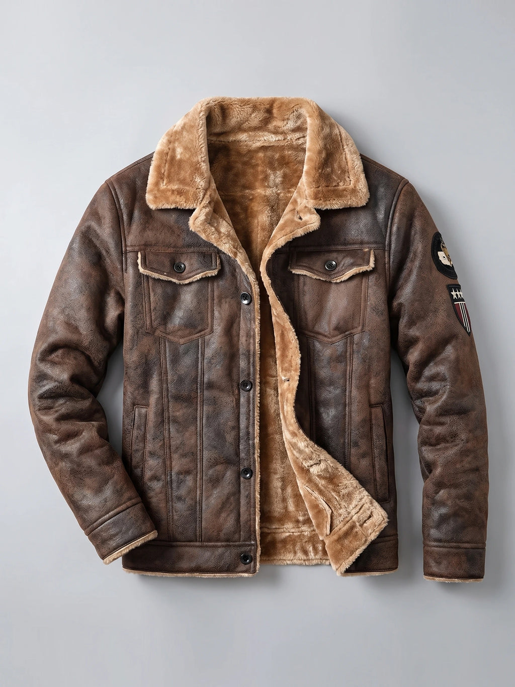 Brown leather jacket laid flat with plush fleece lining, button-front closure, and flap chest pockets.