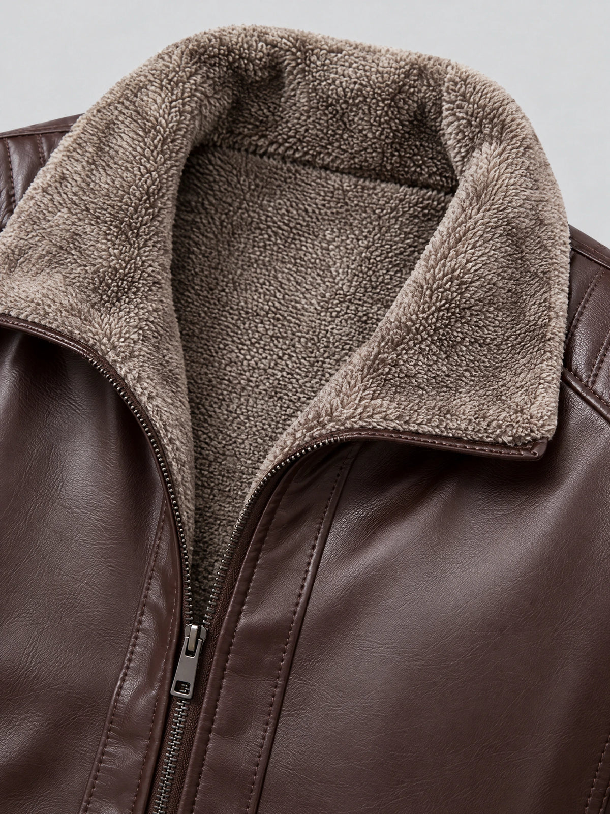 Close-up of the Brown Leather Moto Jacket showing its plush fleece-lined collar, stitched PU leather, and front zipper.