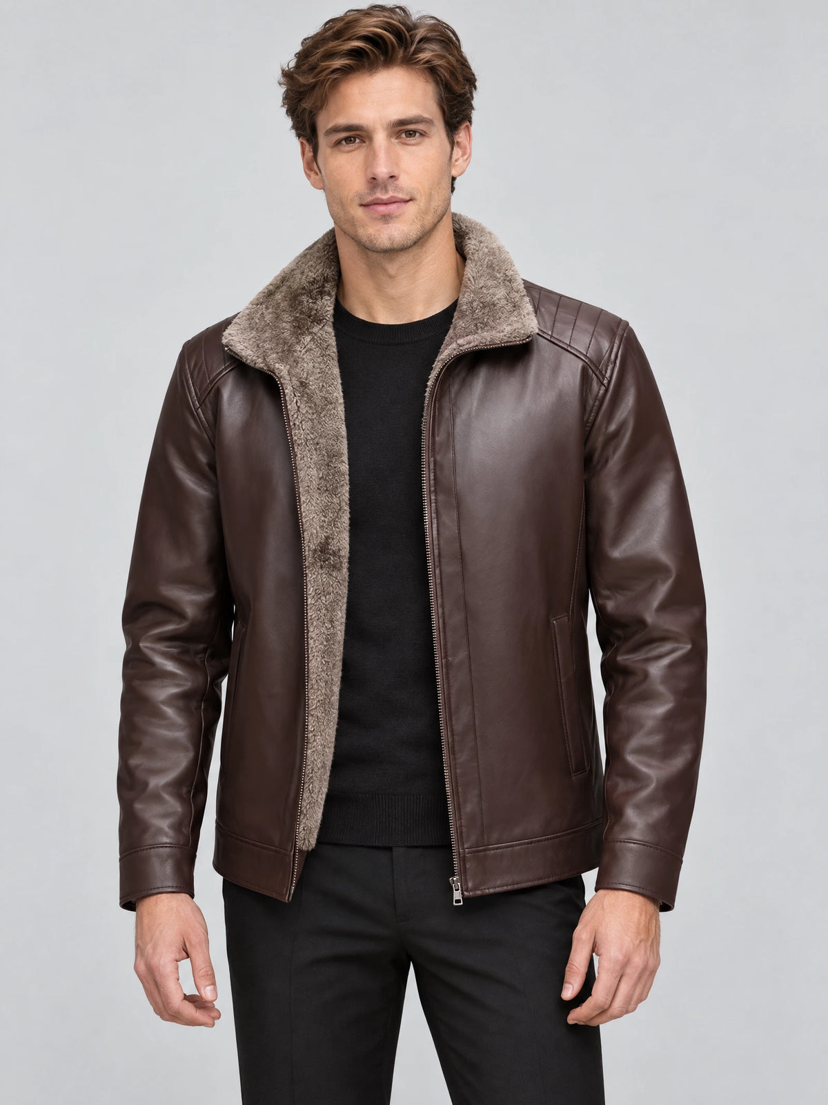 Front studio view of a model wearing a Brown Leather Moto Jacket with a plush-lined collar, zip front, and quilted shoulder panels.