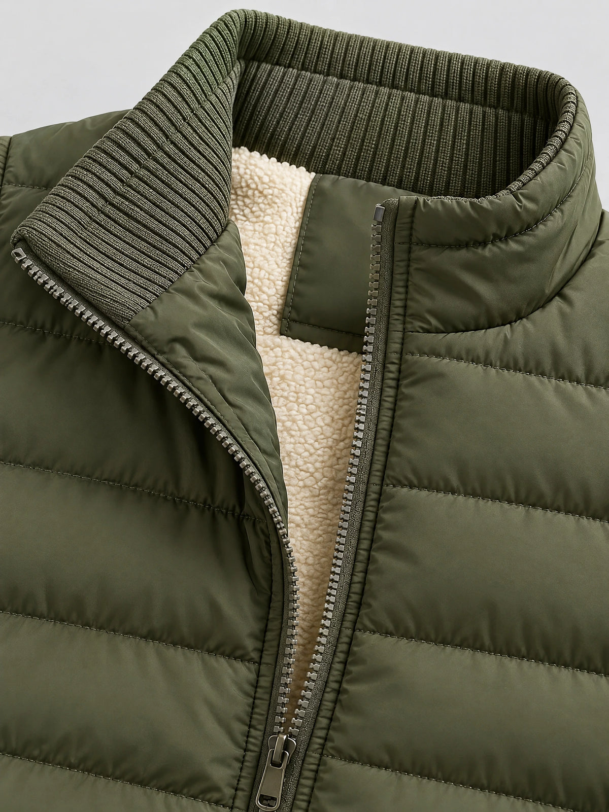 Close-up of the Green lightweight puffer vest with a ribbed stand collar, front zipper, quilted stitching, and soft inner lining.