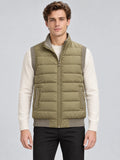 Front studio view of a model wearing a Khaki lightweight puffer vest with a zip front, quilted panels, ribbed trim, and side pockets.