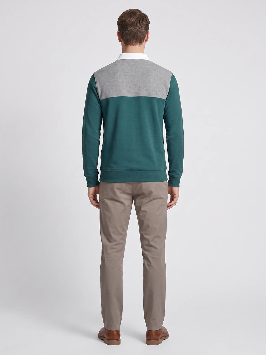 Rear studio view of a model wearing the Gray cotton Long Sleeve Polo with a contrasting back yoke and ribbed cuffs.