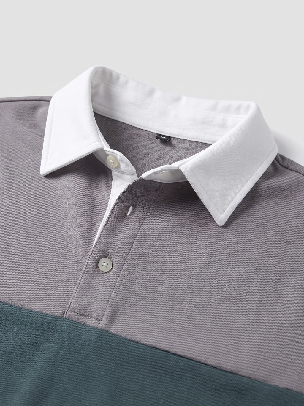 Gray cotton Long Sleeve Polo close-up showing the pointed collar, button placket, and textured fabric.