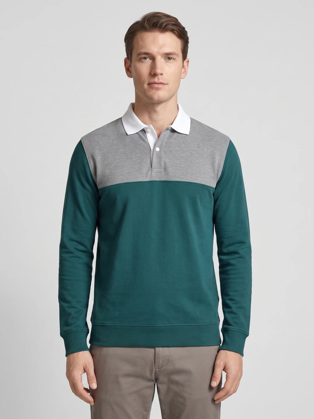 Front studio view of a model wearing a Gray long sleeve polo with a contrasting chest panel, button placket, and ribbed cuffs.